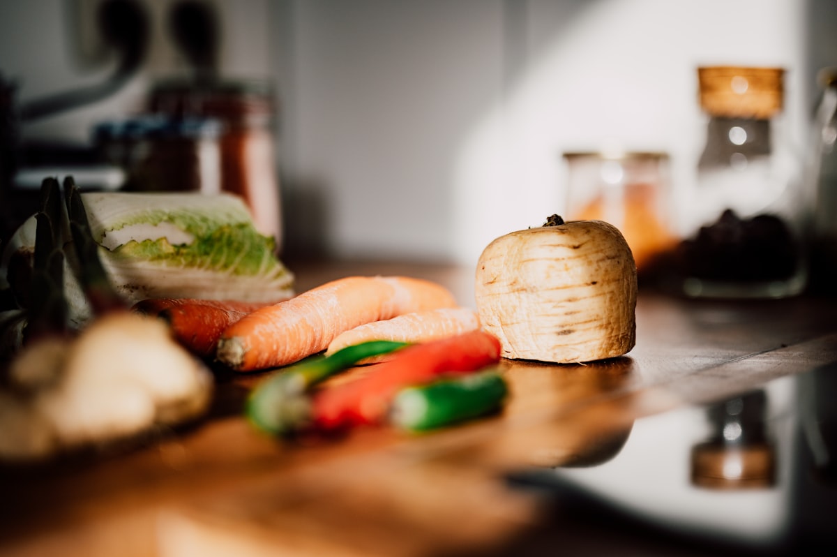Fresh whole foods including vegetables and grains on a wooden table
